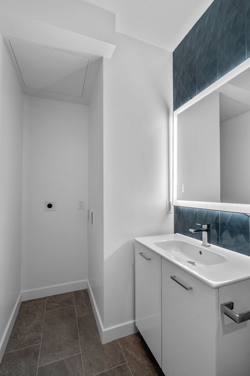 11 Boynton Street, Unit 103 Swampscott, MA 01907 - Photo 37 of 42 a bathroom with a sink and a mirror