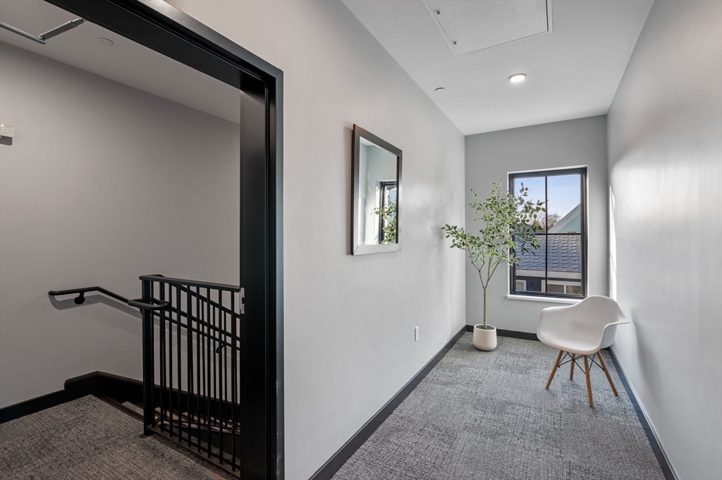 11 Boynton Street, Unit 103 Swampscott, MA 01907 - Photo 38 of 42 a view of a hallway with furniture and windows
