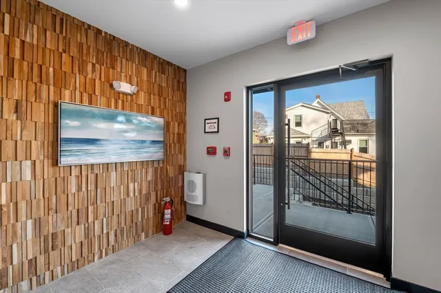 a view of a hallway with wooden floor and windows