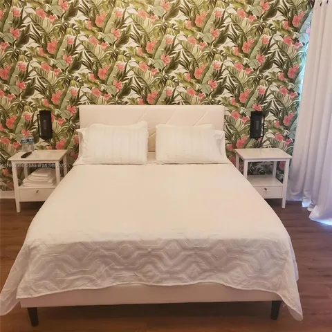 a large white bed in a white room