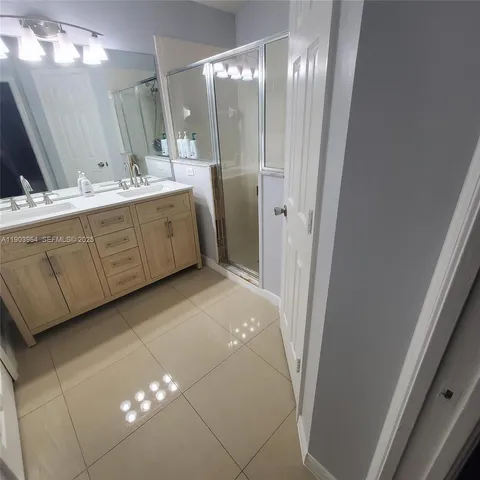 a bathroom with a double vanity sink and mirror