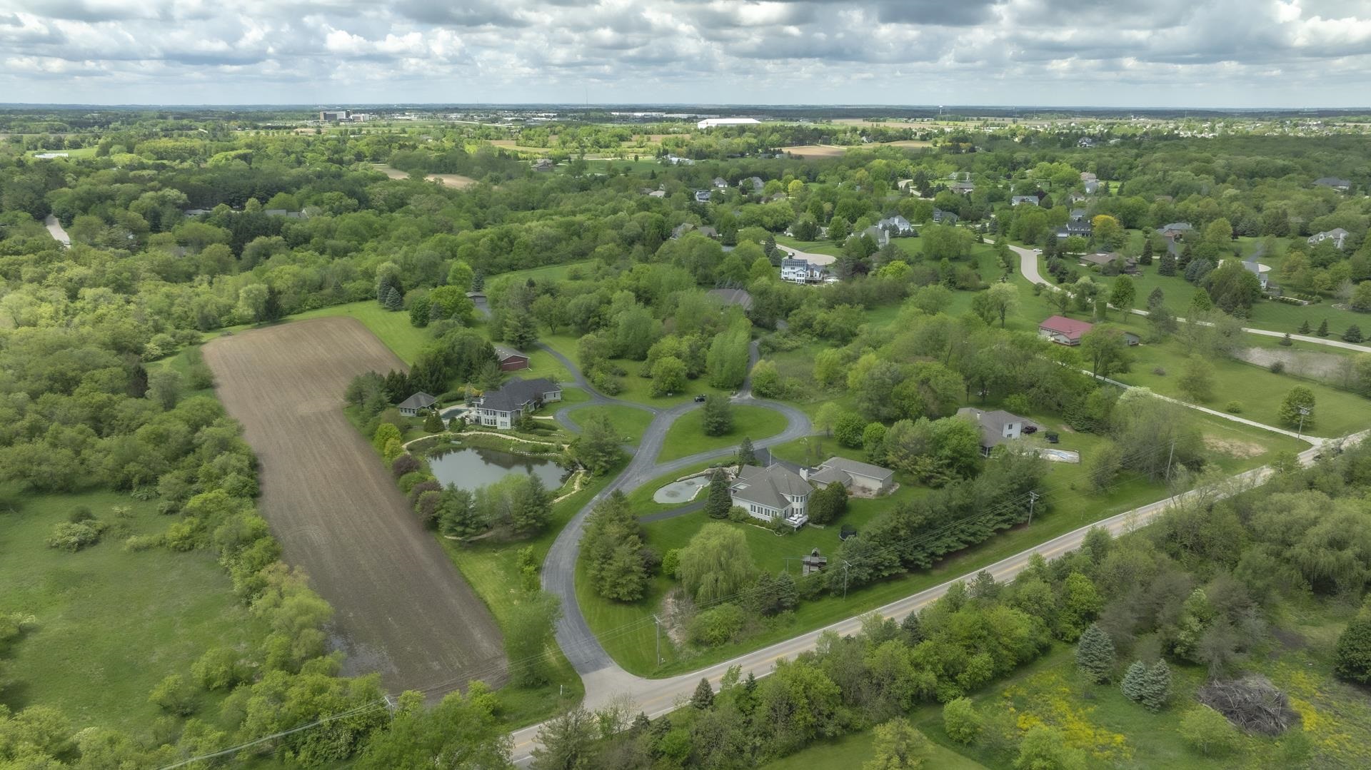 an aerial view of a residential houses with yard and swimming pool
