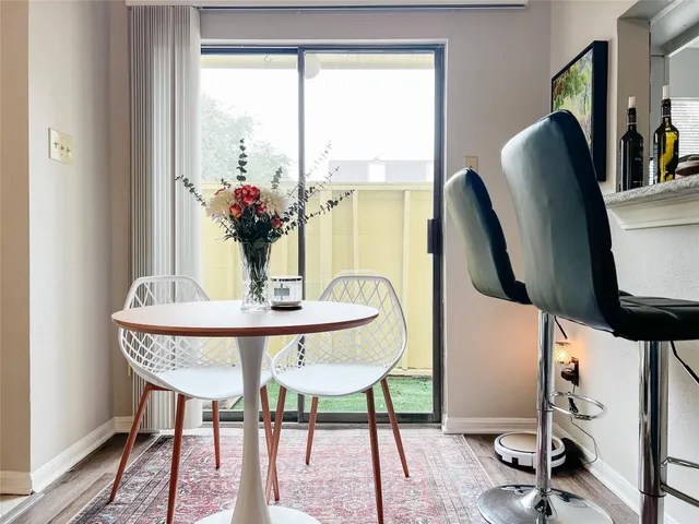 a view of a dining room with furniture and a window