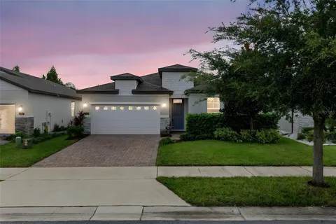 a front view of a house with a yard and a garage