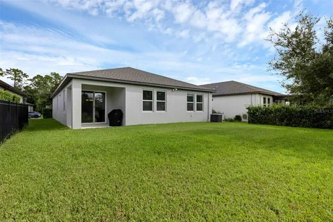 an aerial view of a house with swimming pool garden and patio