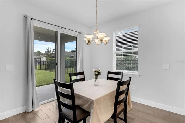 a view of a dining room with furniture wooden floor and chandelier