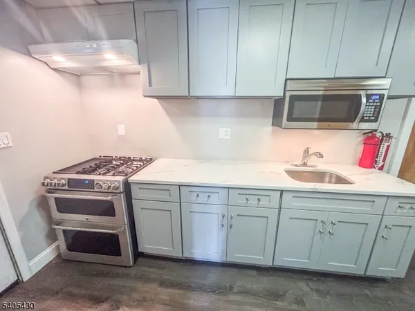 a kitchen with a sink stove and cabinets