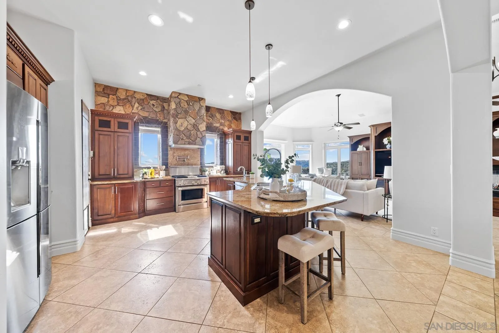 13170 Rancho Heights Road Pala, CA 92059 - Photo 13 of 75 a kitchen with stainless steel appliances kitchen island granite countertop a sink a counter and chairs