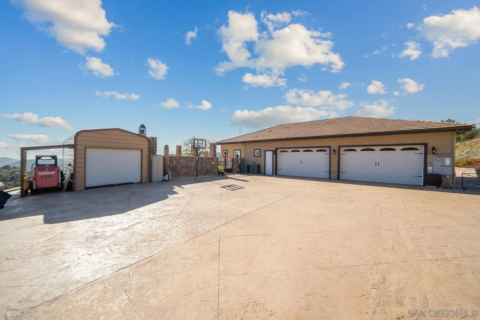 13170 Rancho Heights Road Pala, CA 92059 - Photo 61 of 75 a front view of a house with a yard and garage