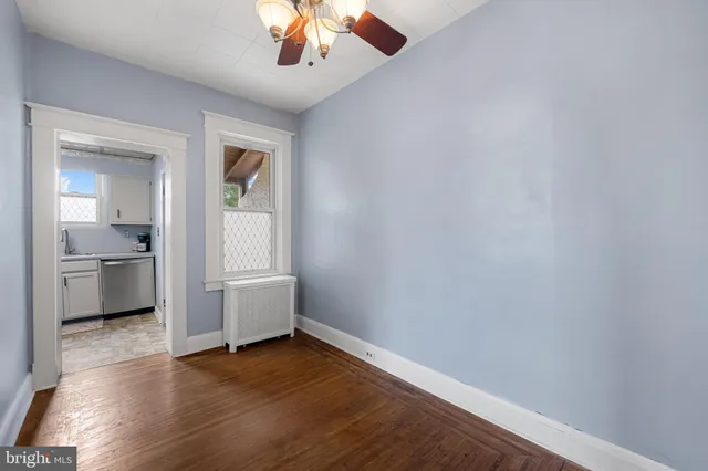 wooden floor in an empty room and a kitchen