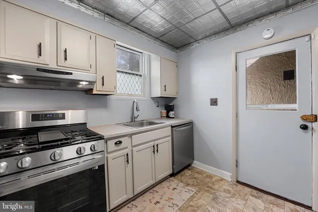 a kitchen with stainless steel appliances granite countertop a stove and a refrigerator