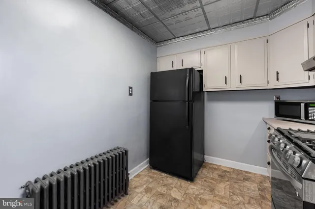 a kitchen with stainless steel appliances a refrigerator and cabinets