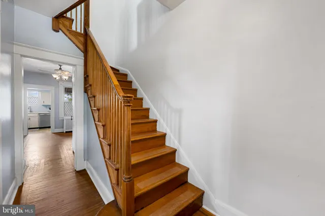 a view of entryway and hall with wooden floor