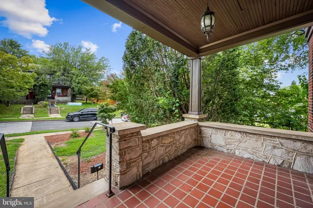 a view of a porch with furniture and garden