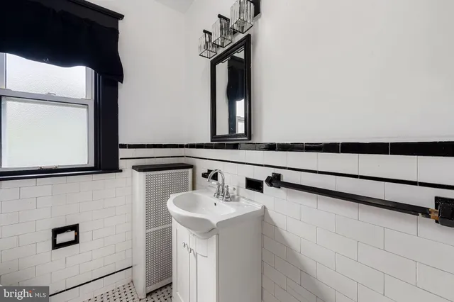 a bathroom with a sink a mirror and a window