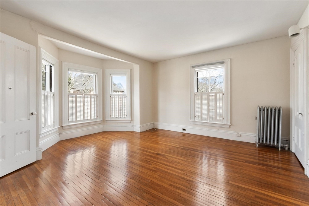 95 Hubbard Street, Unit 95 Concord, MA 01742 - Photo 11 of 22 a view of an empty room with wooden floor and a window
