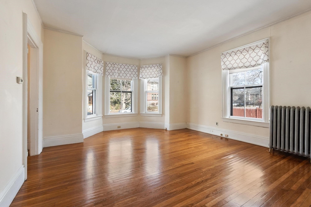 95 Hubbard Street, Unit 95 Concord, MA 01742 - Photo 2 of 22 a view of an empty room with wooden floor and a window
