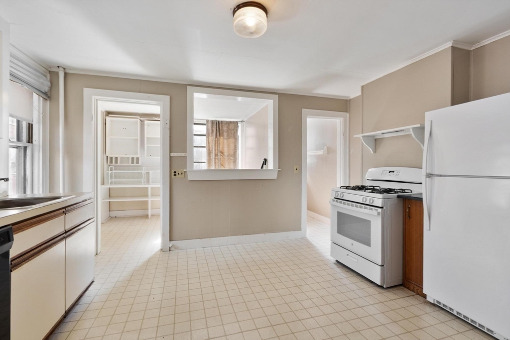 95 Hubbard Street, Unit 95 Concord, MA 01742 - Photo 4 of 22 a kitchen with granite countertop a refrigerator and a stove top oven