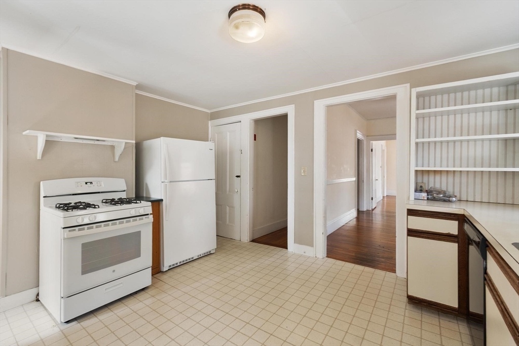 95 Hubbard Street, Unit 95 Concord, MA 01742 - Photo 6 of 22 a kitchen with stainless steel appliances granite countertop a refrigerator a stove and a sink with wooden floor