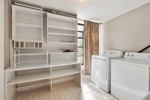 a view of storage and utility room with washer and dryer