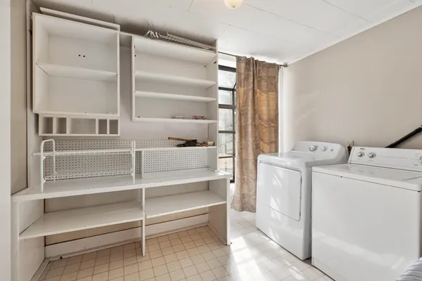 a view of storage and utility room with washer and dryer
