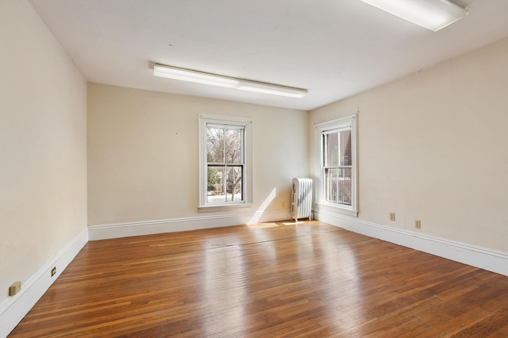 95 Hubbard Street, Unit 95 Concord, MA 01742 - Photo 10 of 22 a view of empty room with wooden floor and fan