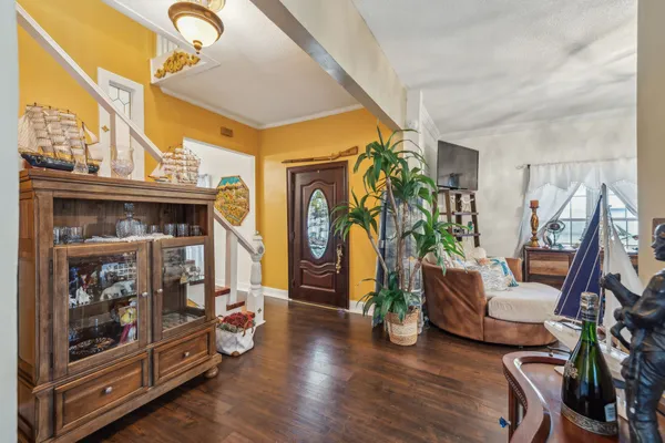 a living room with furniture a chandelier and a clock