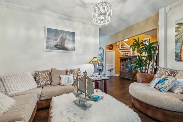 a dining room with furniture a sink a refrigerator and a dining table with wooden floor