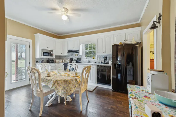 a kitchen with white cabinets and stainless steel appliances