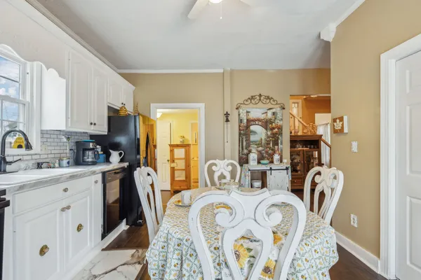 a room with a refrigerator and a wooden floor
