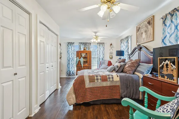 a bedroom with a bed dresser and a window