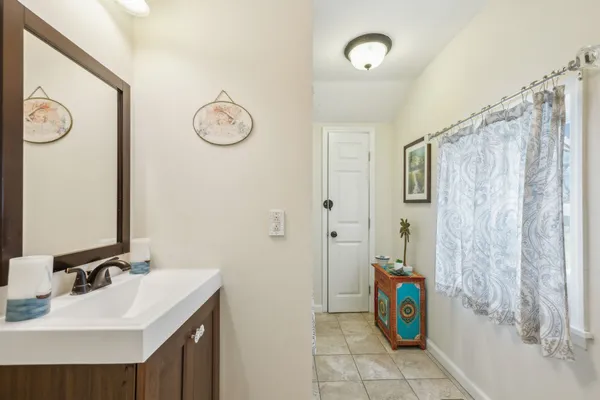 a bathroom with a granite countertop sink a toilet and shower