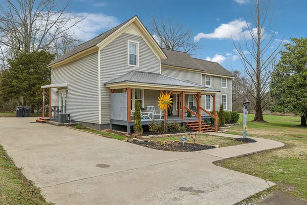 a view of a house with backyard porch and sitting area
