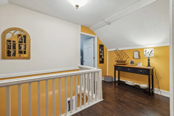 a spacious bedroom with a bed and a flat screen tv