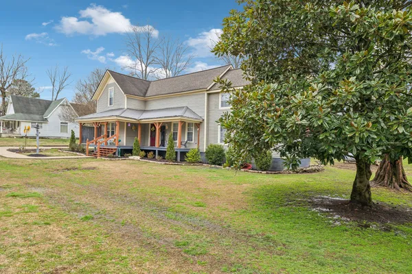 a front view of a house with a big yard