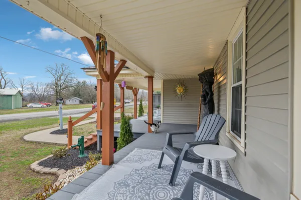 a view of a porch with furniture and garden