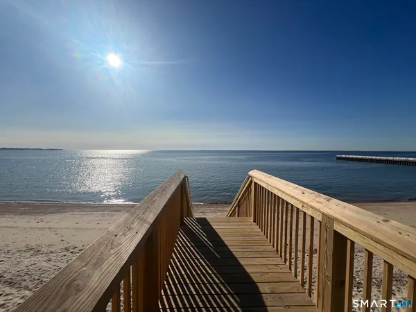 a view of roof deck with wooden floor and fence