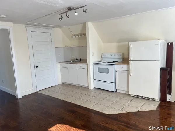 a kitchen with a white cabinets and white appliances