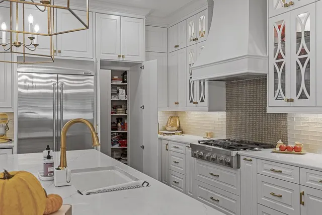a view of a dining room and livingroom with furniture wooden floor a chandelier