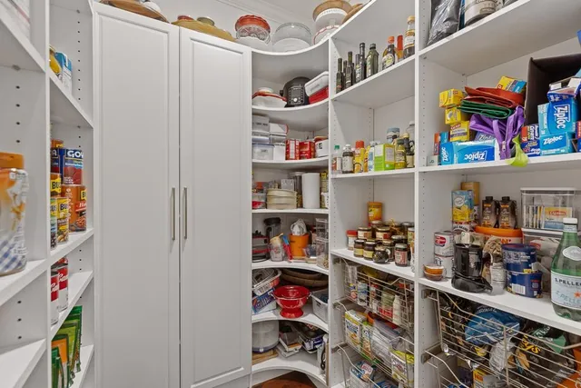a view of a dining room and livingroom with furniture wooden floor a chandelier
