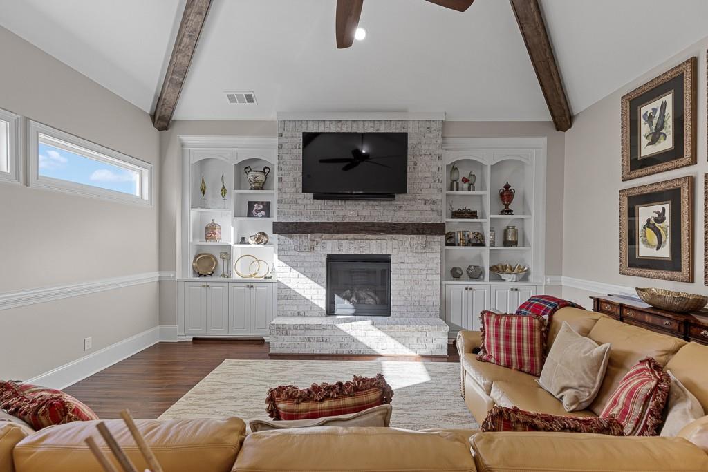 2794 Cork Street Hoschton, GA 30548 - Photo 20 of 51 a living room with furniture and a fireplace