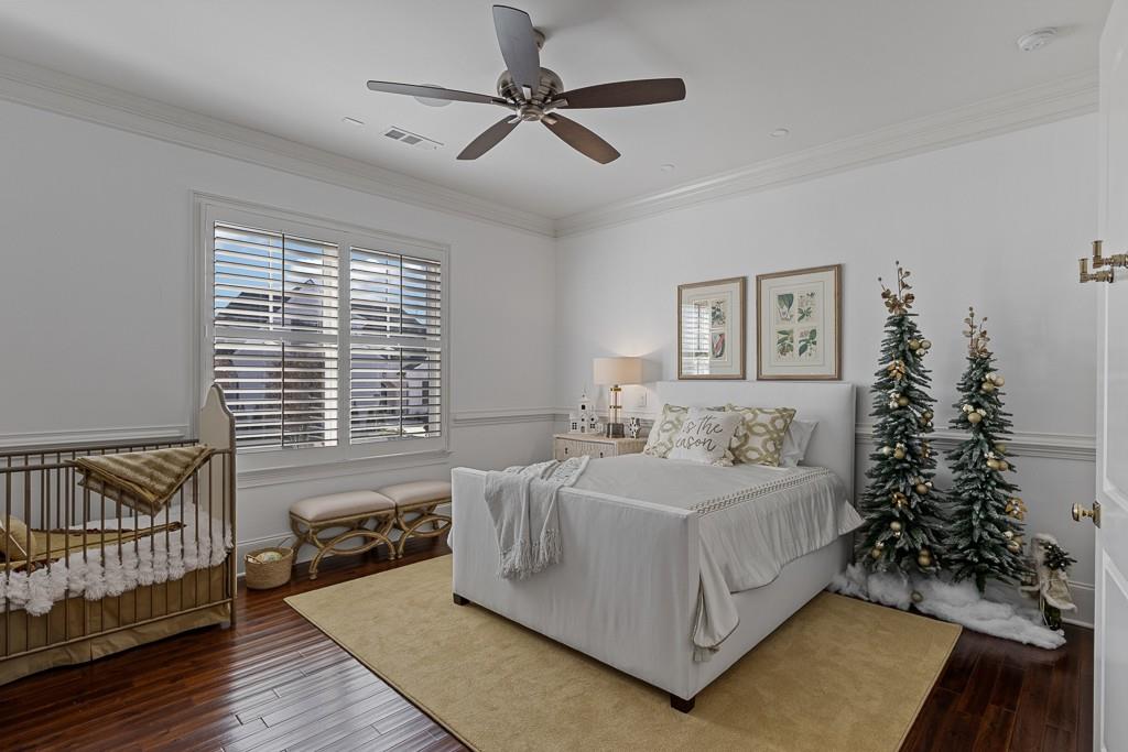 2794 Cork Street Hoschton, GA 30548 - Photo 23 of 51 a bedroom with a bed and a chandelier