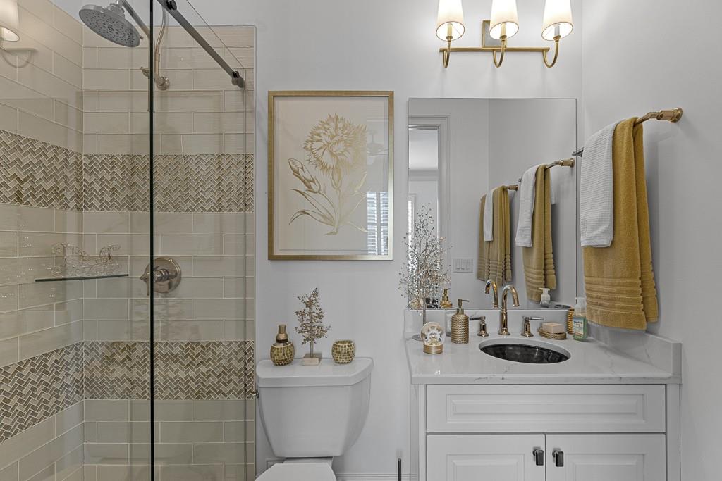 2794 Cork Street Hoschton, GA 30548 - Photo 26 of 51 a bathroom with a sink a toilet and shower