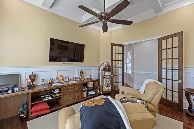 a bedroom with a bed and a flat tv screen on dresser