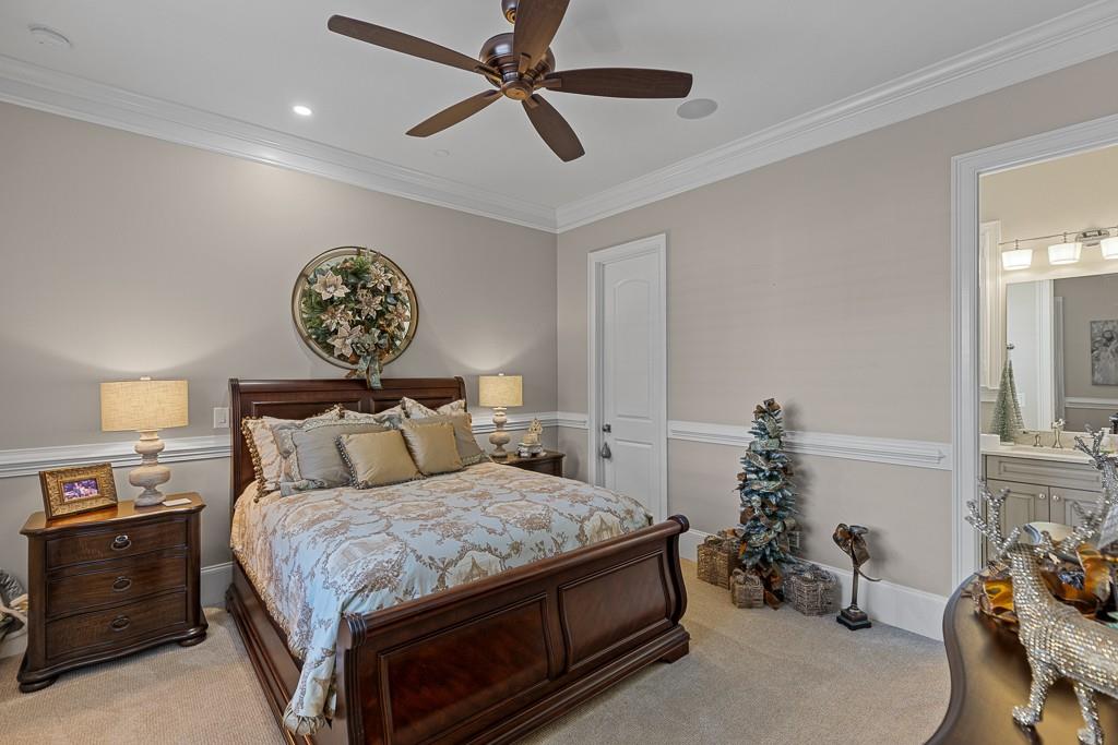 2794 Cork Street Hoschton, GA 30548 - Photo 30 of 51 a bedroom with a bed and a chandelier