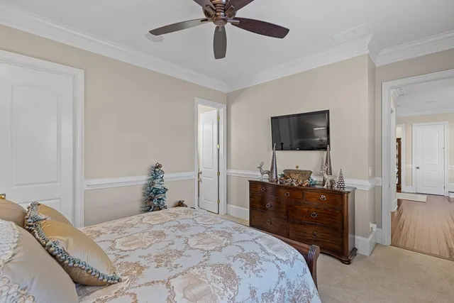 a spacious bedroom with a bed and a chandelier