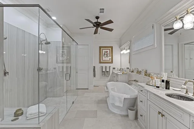 a bathroom with a double vanity sink mirror and shower