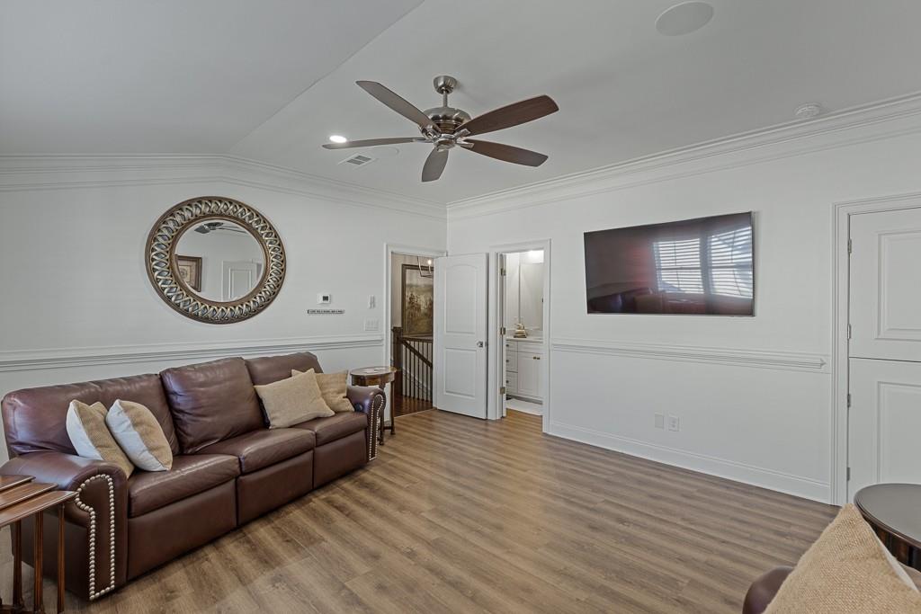 2794 Cork Street Hoschton, GA 30548 - Photo 44 of 51 a living room with furniture and a wooden floor