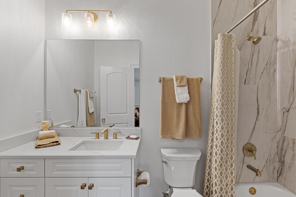 2794 Cork Street Hoschton, GA 30548 - Photo 45 of 51 a bathroom with a sink a toilet and shower