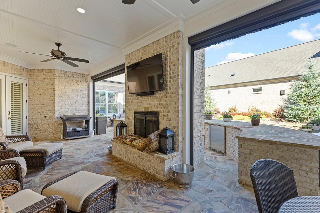 2794 Cork Street Hoschton, GA 30548 - Photo 49 of 51 a living room with furniture fireplace and a flat screen tv